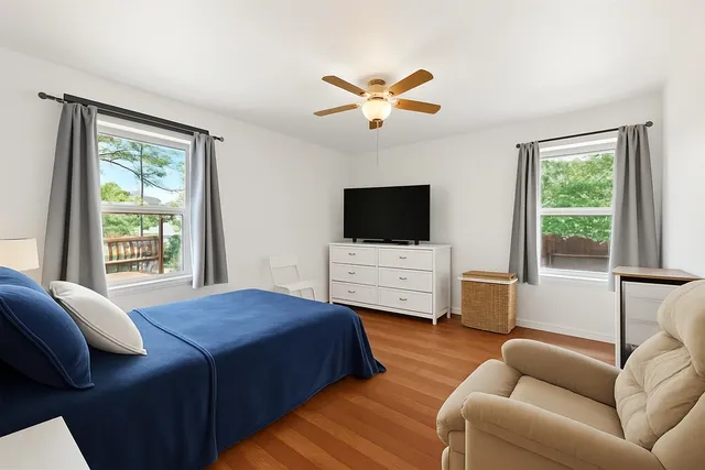 a bedroom with a bed and a flat screen television