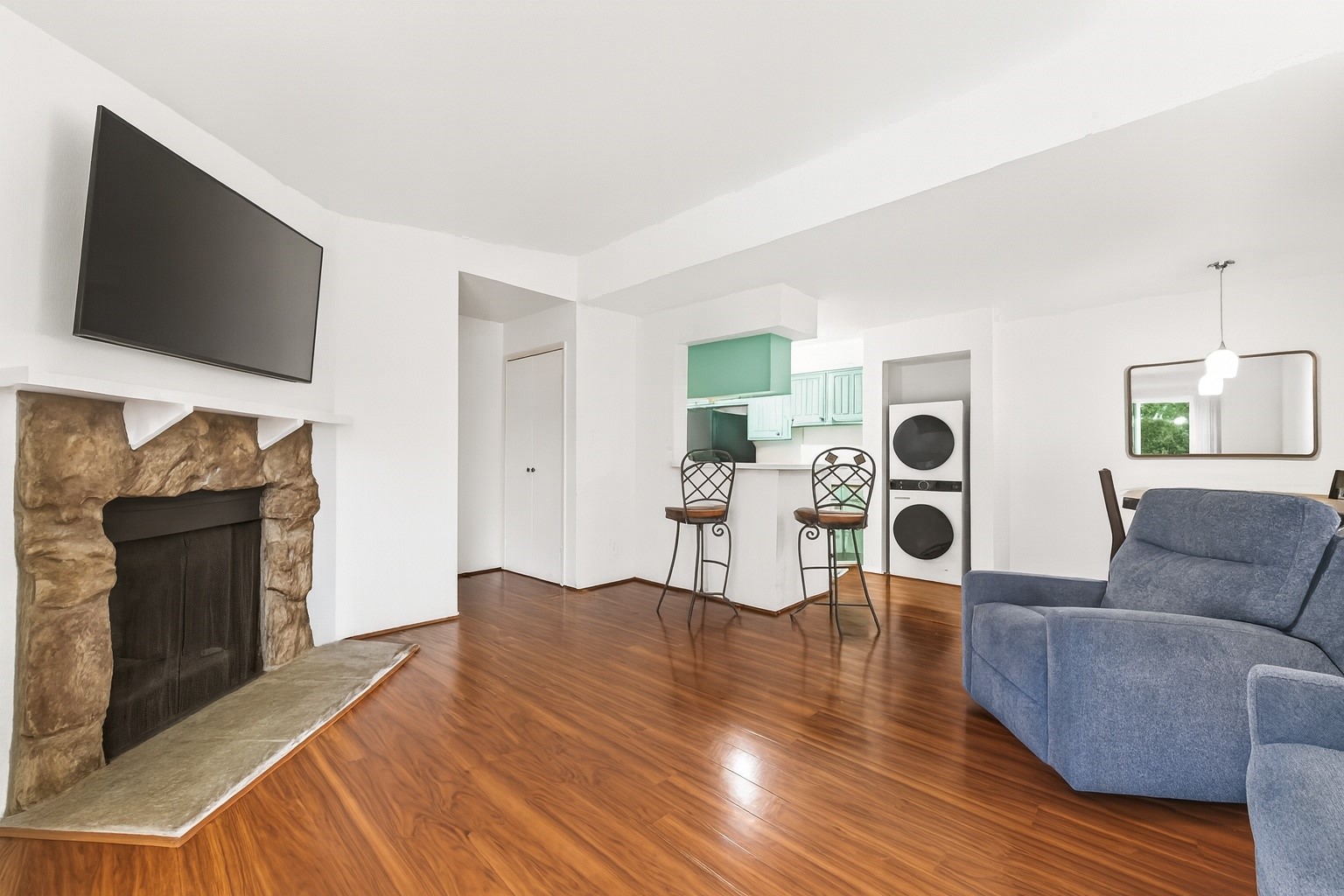 6001 Reims Road, Unit 908 Houston, TX 77036 - Photo 6 of 31 a living room with furniture a flat screen tv and a fireplace