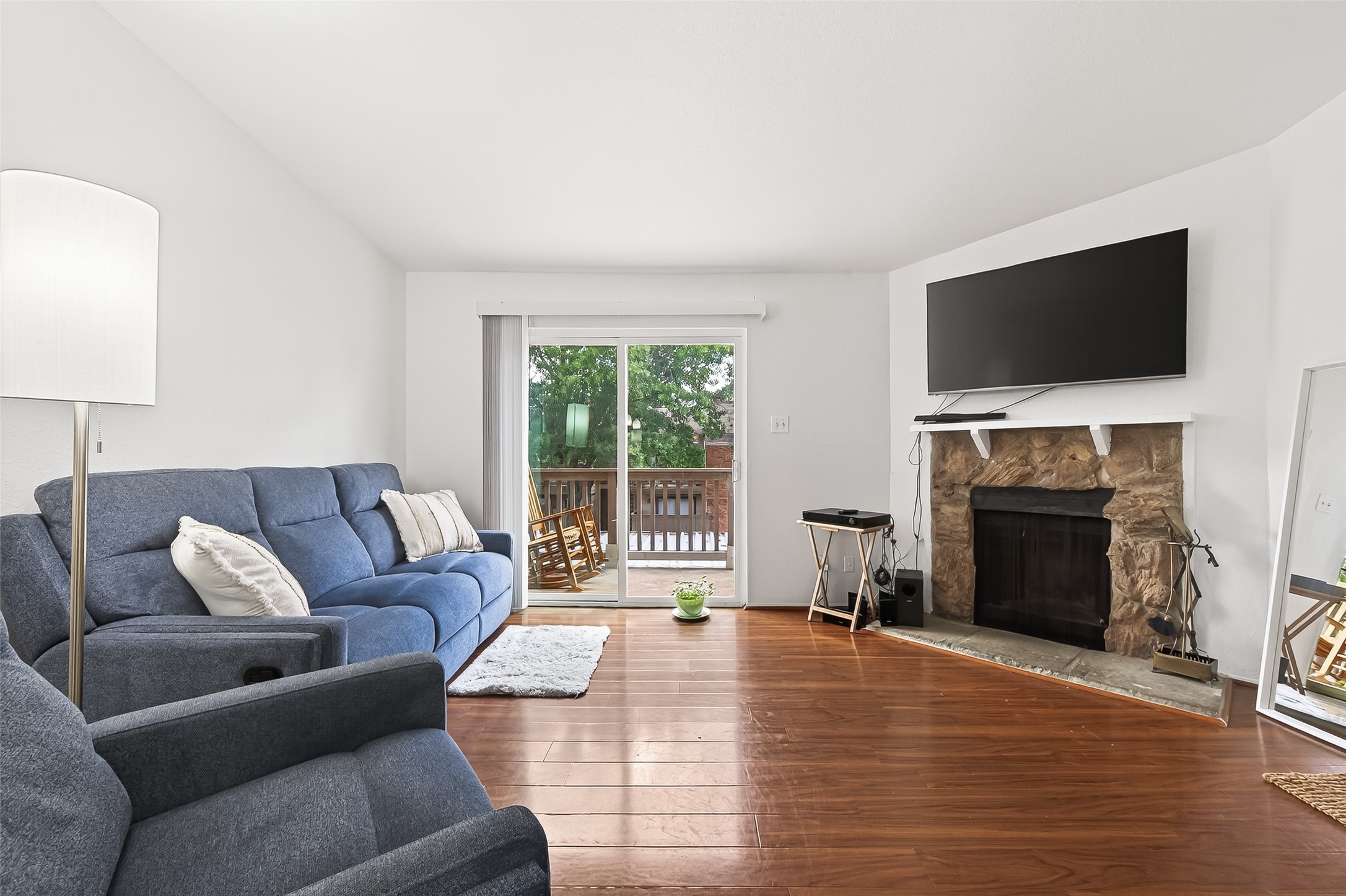 6001 Reims Road, Unit 908 Houston, TX 77036 - Photo 7 of 31 a living room with furniture a flat screen tv and a fireplace