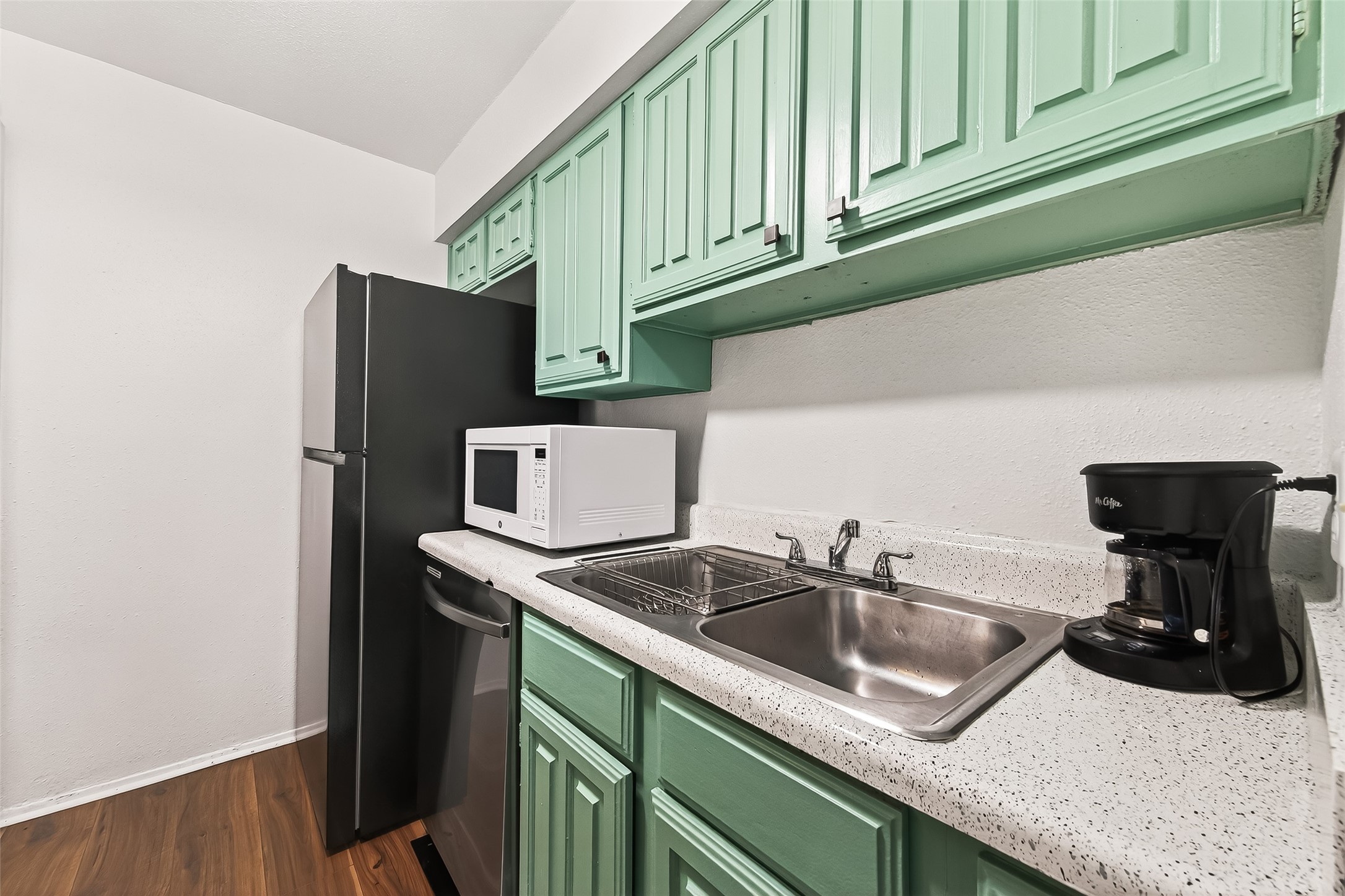 6001 Reims Road, Unit 908 Houston, TX 77036 - Photo 10 of 31 a kitchen with stainless steel appliances granite countertop a sink and a refrigerator
