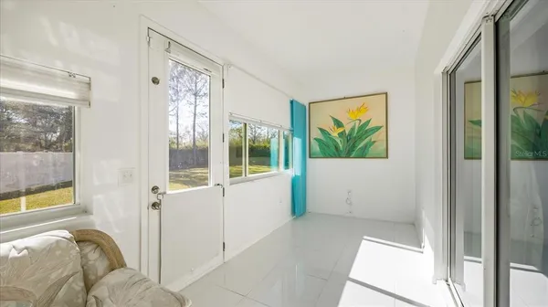 a view of a bedroom with furniture and windows