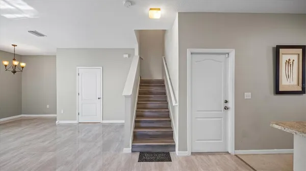 an entryway with a white walls and stairs