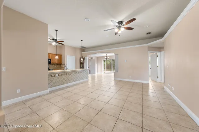 a view of a hallway with wooden floor and chandelier