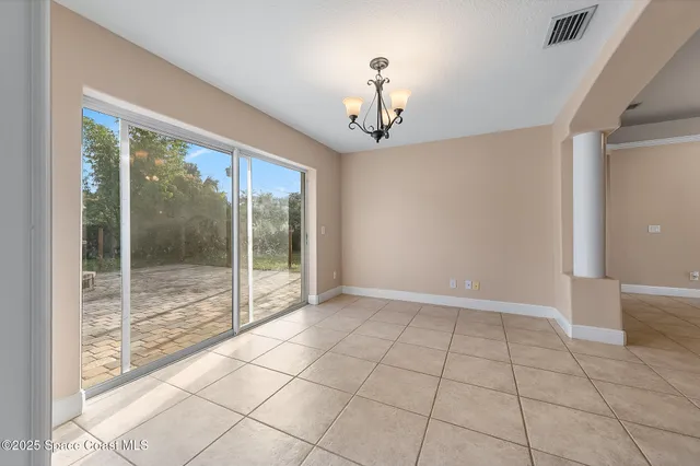 a large kitchen with kitchen island granite countertop a stove a sink a oven with a dining table and chairs