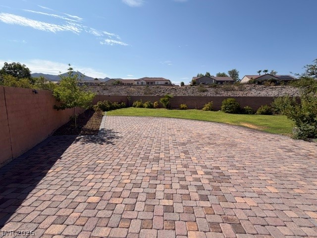 19 Mohansic Road Henderson, NV 89052 - Photo 29 of 30 A spacious paver patio and lawn area provide an ideal setting for outdoor entertaining.