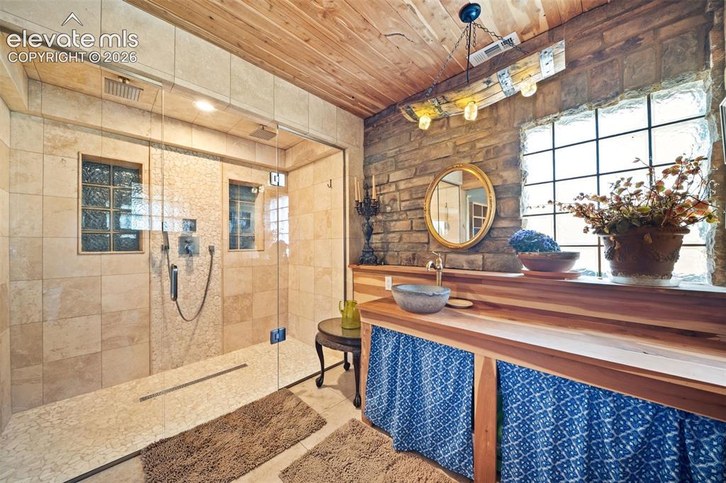 351 High Pasture Road Florissant, CO 80816 - Photo 21 of 39 Primary en-suite with a custom tile shower and Delta fixtures.