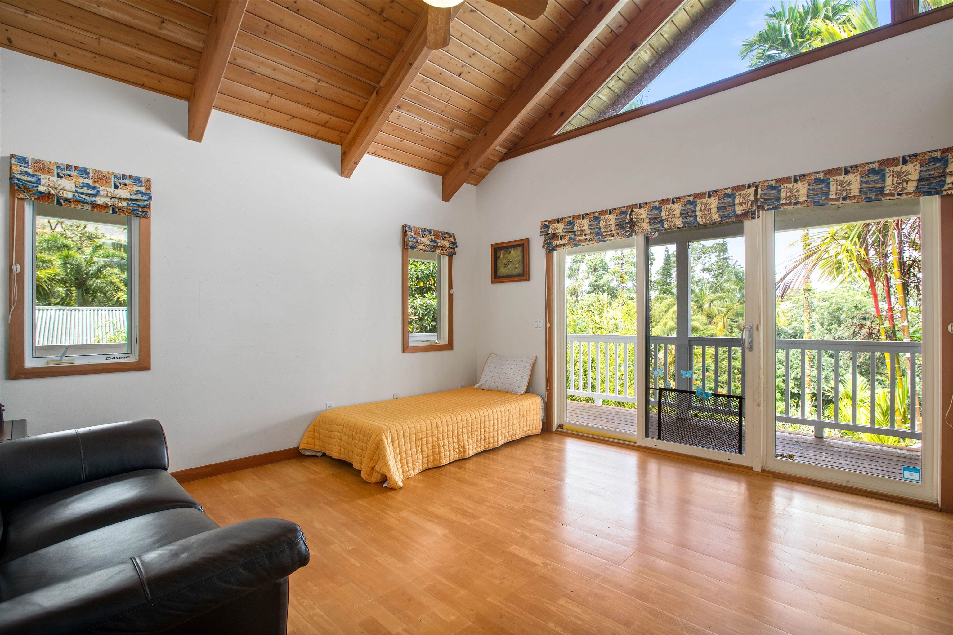 285 Kalo Road Hana, HI 96713 - Photo 19 of 36 a bedroom with a bed and wooden floor