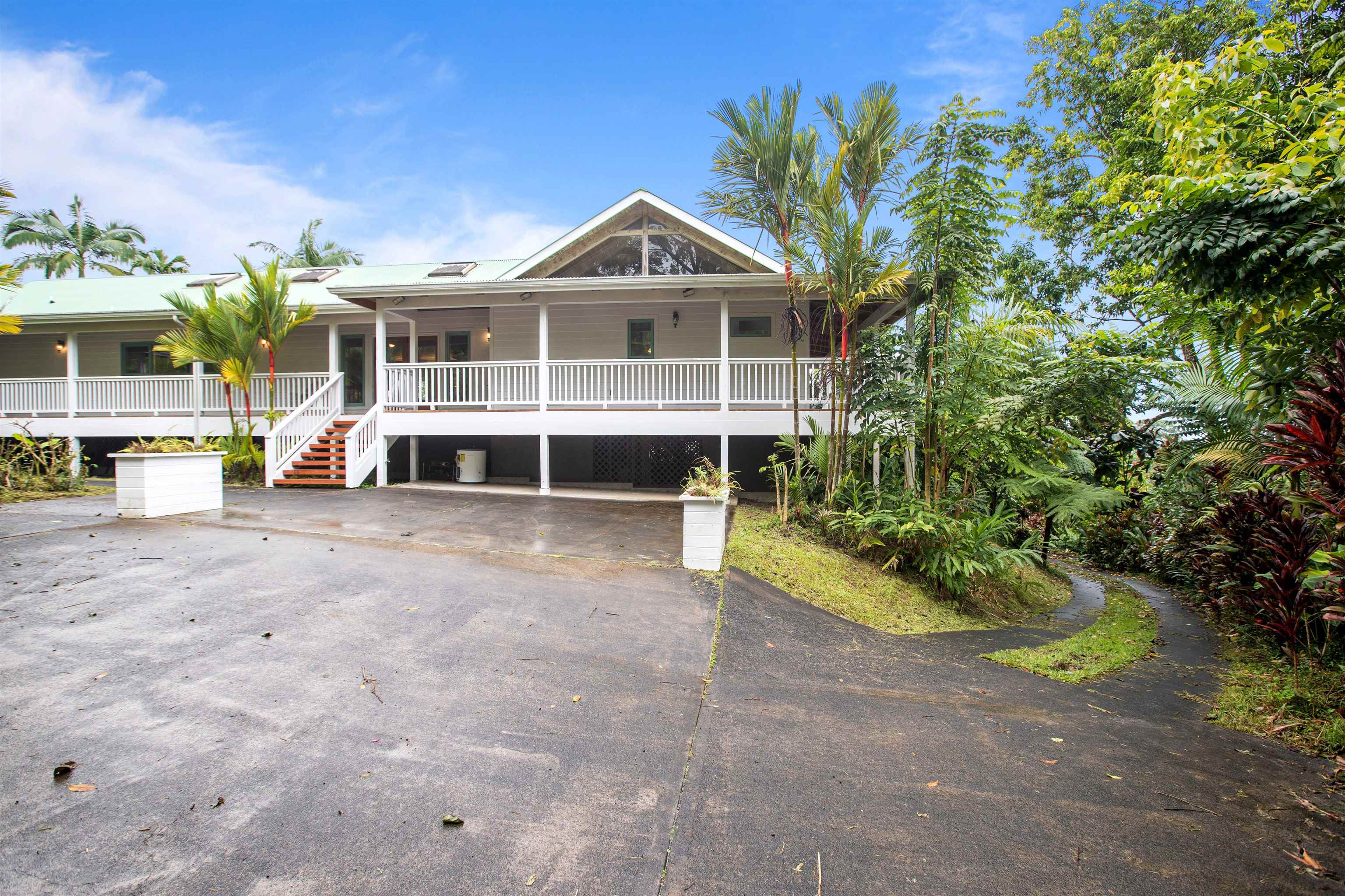 285 Kalo Road Hana, HI 96713 - Photo 31 of 36 a view of a house with a yard and large trees