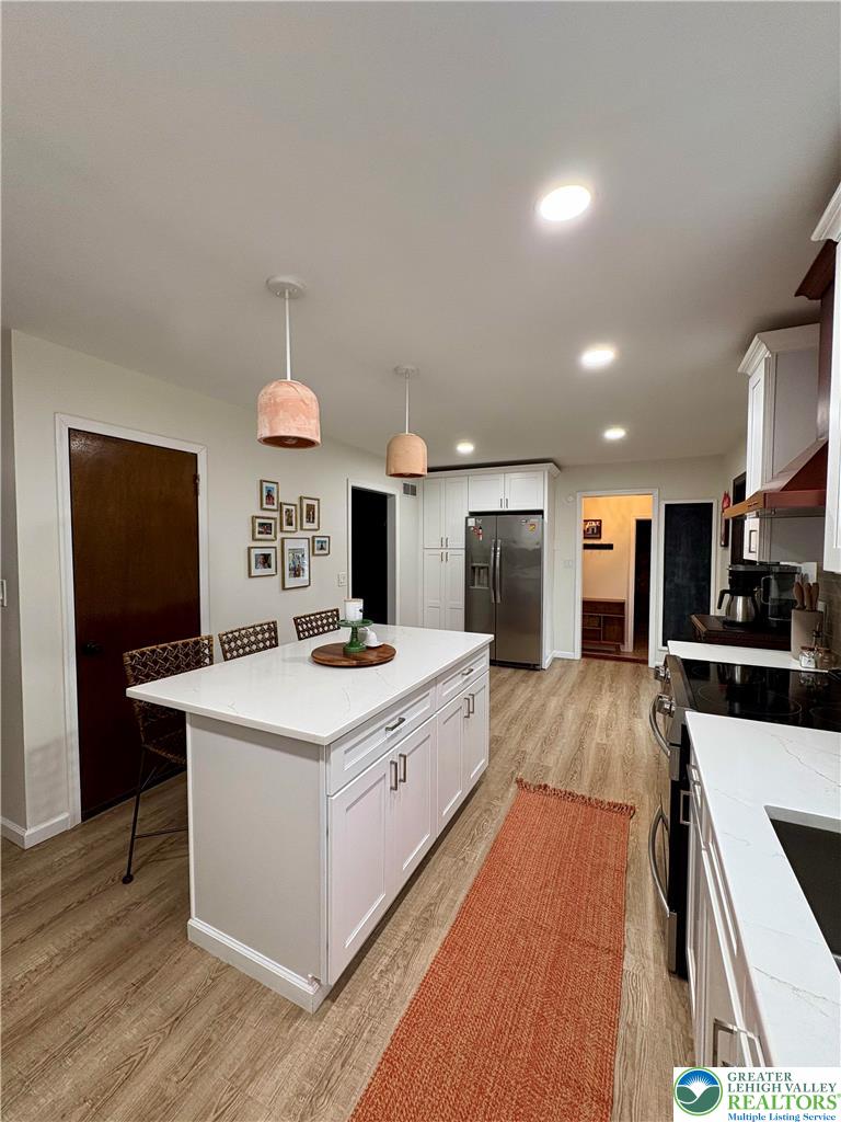 375 Georgetown Road Nazareth, PA 18064 - Photo 7 of 21 a large kitchen with stainless steel appliances a stove a sink dishwasher a refrigerator and white cabinets with wooden floor