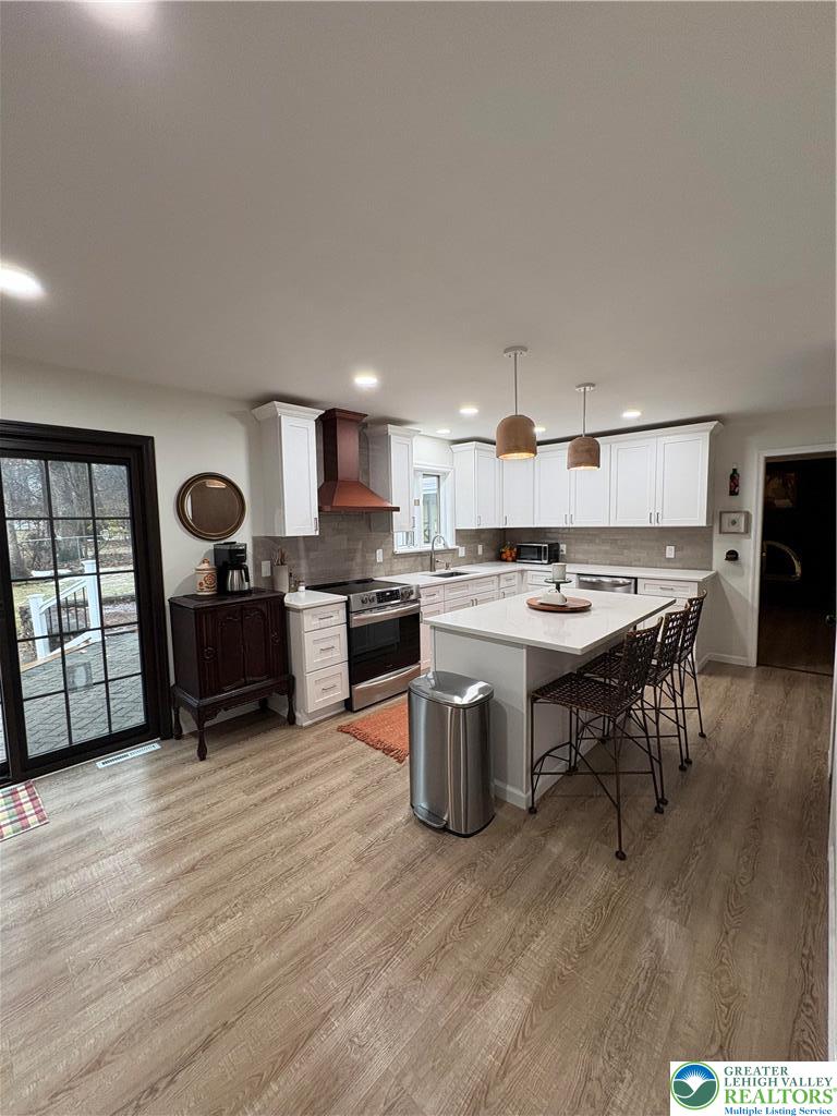 375 Georgetown Road Nazareth, PA 18064 - Photo 8 of 21 a open kitchen with stainless steel appliances granite countertop a stove top oven a sink dishwasher a dining table and chairs with wooden floor