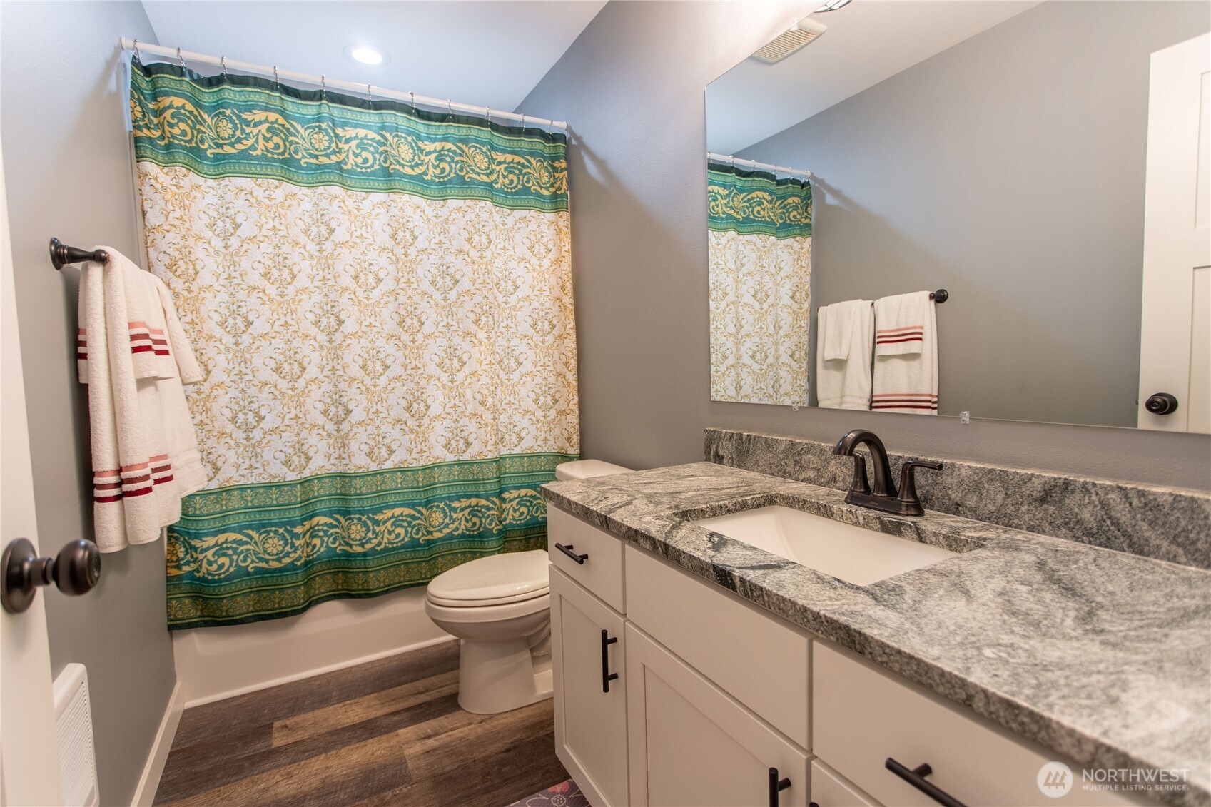 2915 Jackson Highway, Unit D Chehalis, WA 98532 - Photo 12 of 24 a bathroom with a granite countertop toilet a sink and a mirror