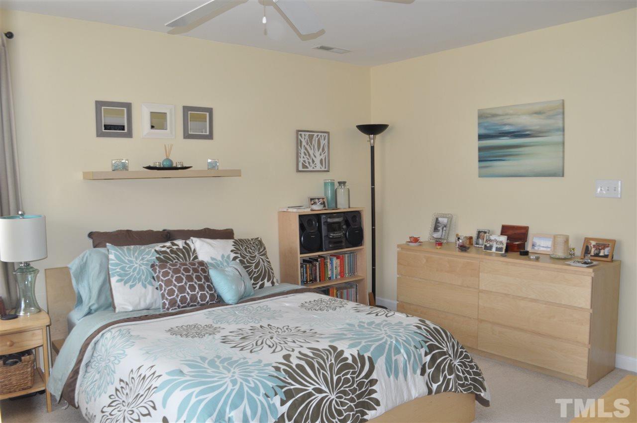 720 Parkham Lane Raleigh, NC 27603 - Photo 12 of 23 a bedroom with a bed and a lamp on dresser