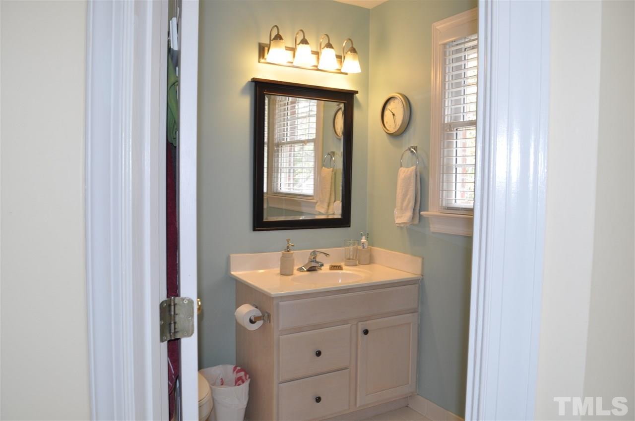 720 Parkham Lane Raleigh, NC 27603 - Photo 14 of 23 a bathroom with a sink vanity and a mirror