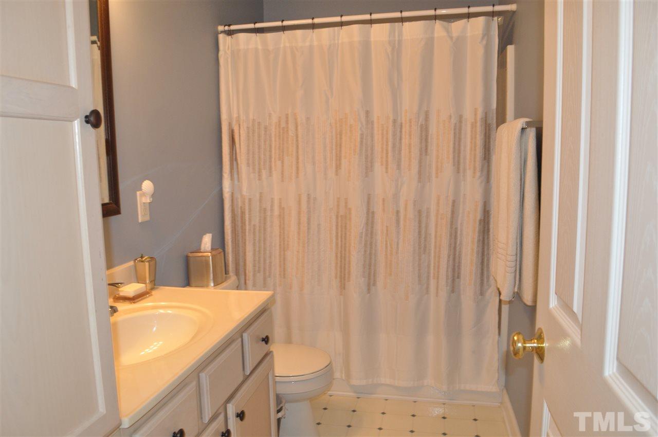 720 Parkham Lane Raleigh, NC 27603 - Photo 18 of 23 a bathroom with a granite countertop sink and a mirror