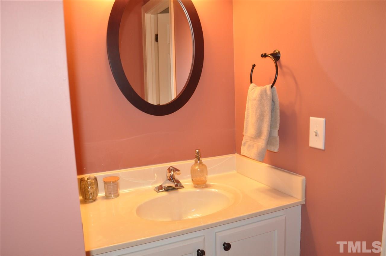 720 Parkham Lane Raleigh, NC 27603 - Photo 20 of 23 a bathroom with a sink and a mirror