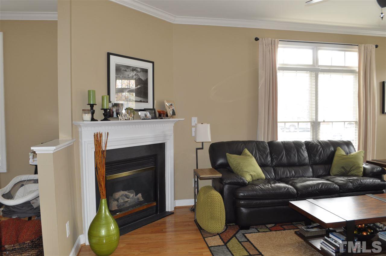 720 Parkham Lane Raleigh, NC 27603 - Photo 10 of 23 a living room with furniture a window and a fireplace