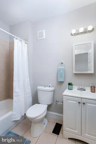 a white toilet sitting next to a bathroom sink