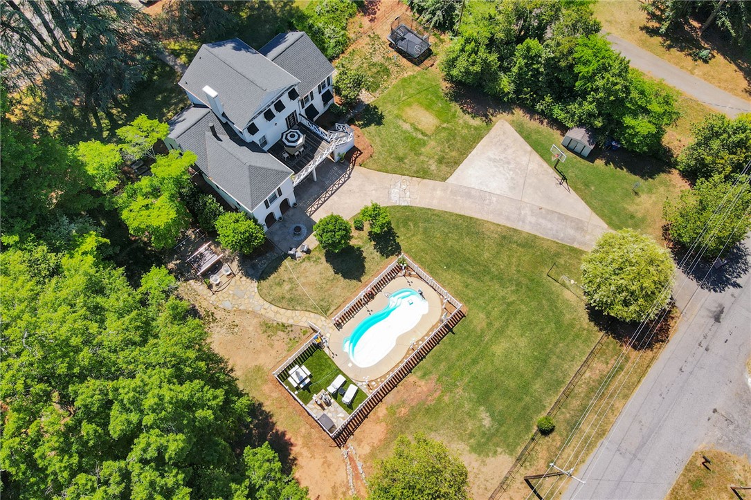 1107 Springdale Road Anderson, SC 29621 - Photo 44 of 49 An aerial view captures a sprawling property featuring a refreshing pool and ample outdoor space.