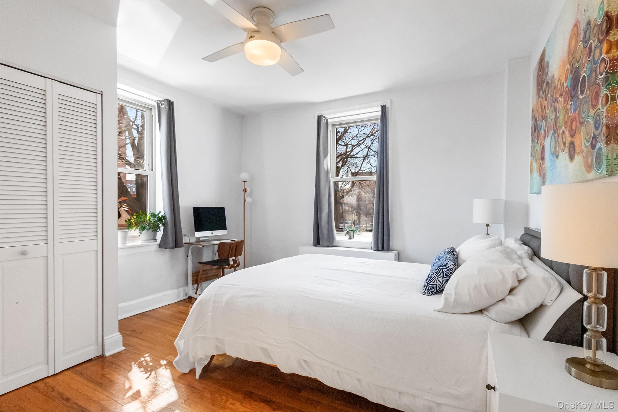 43-10 48th Avenue, Unit 2F Queens, NY 11377 - Photo 5 of 14 a bedroom with a bed and a window