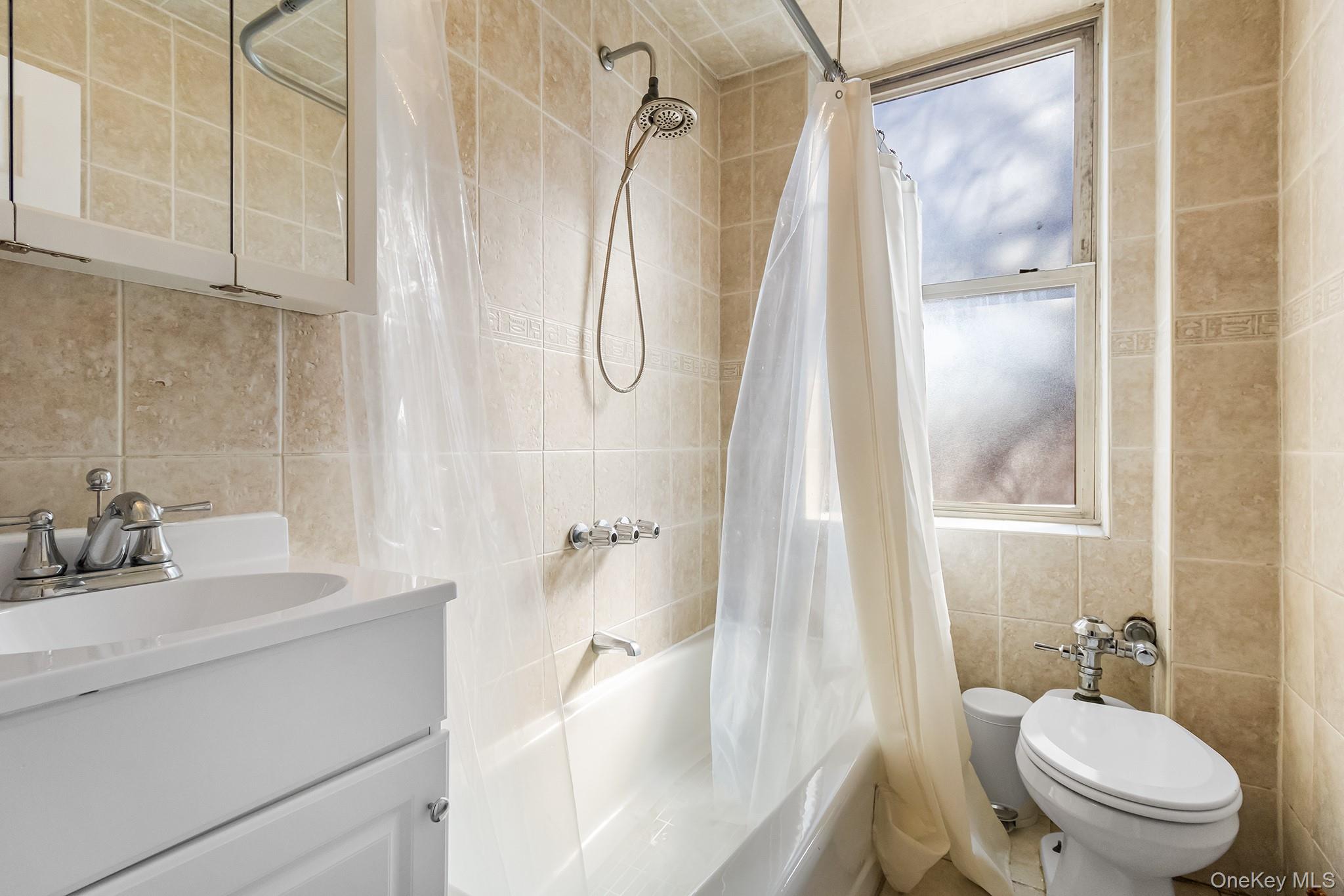 43-10 48th Avenue, Unit 2F Queens, NY 11377 - Photo 7 of 14 a bathroom with a sink toilet and shower