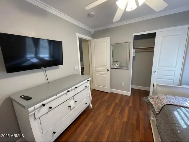 a living room with hard wood floor and a flat screen tv