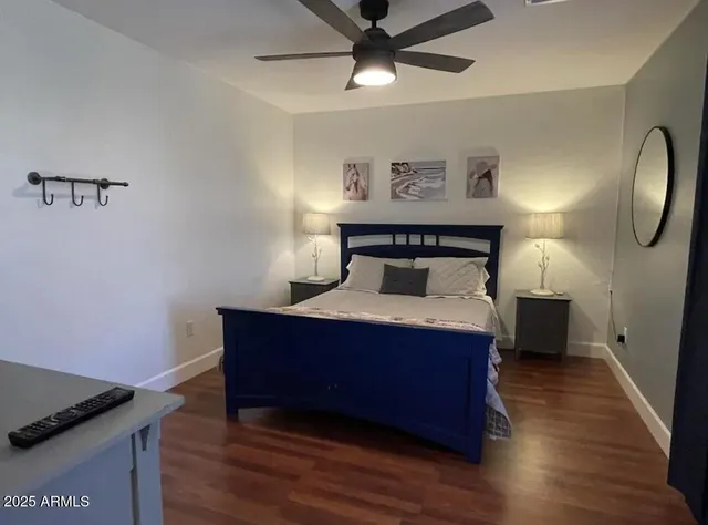 a room with a bed and wooden floor