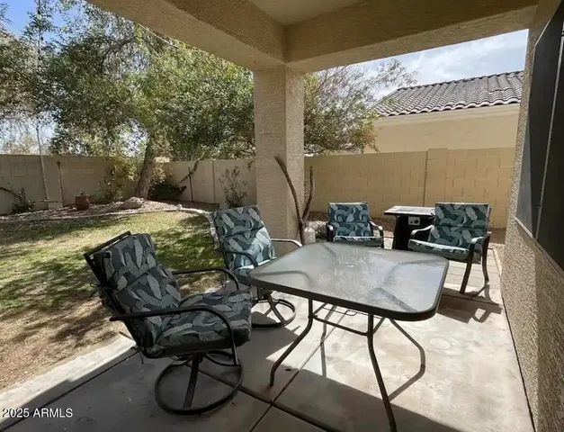 a view of a backyard with table and chairs and couches