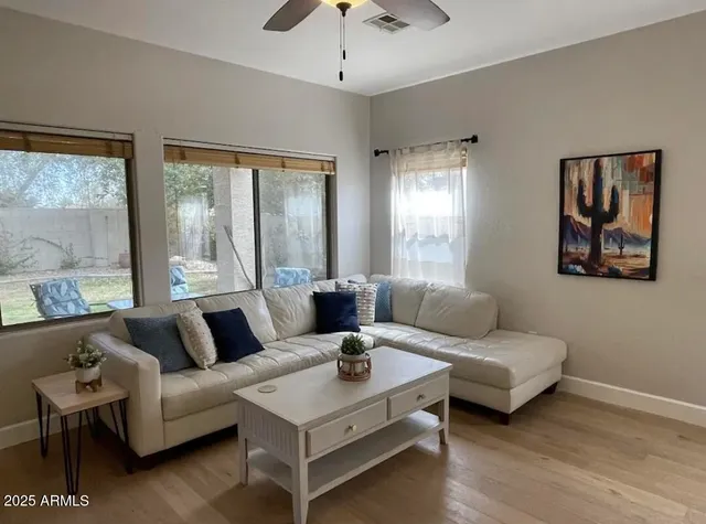 a living room with furniture and a large window