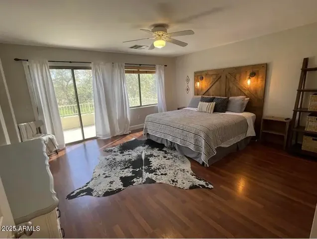 a spacious bedroom with a large bed and a chandelier