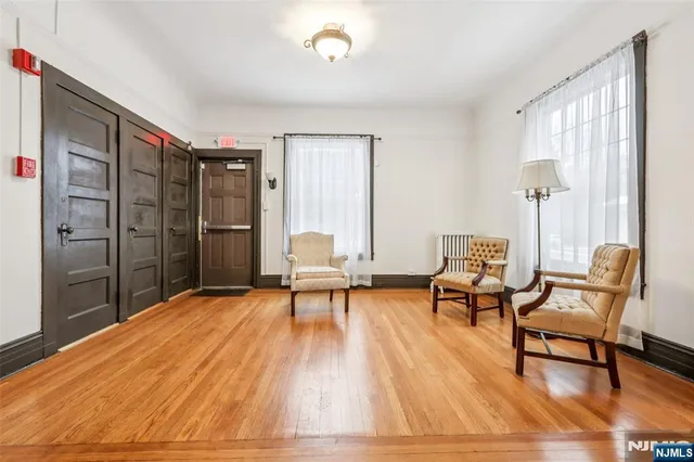 a view of a kitchen with a sink and wooden floor