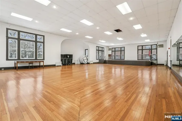 a view of a room with wooden floor