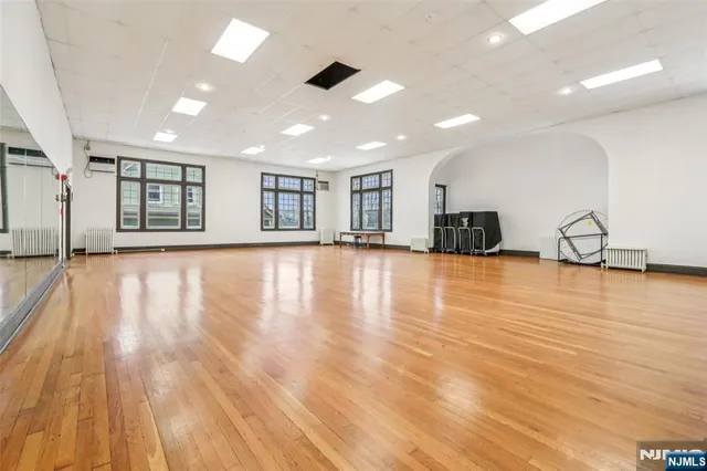 a large room with wooden floor and furniture