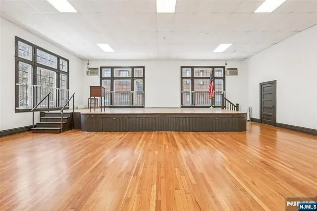 a view of kitchen with wooden floor and seating space