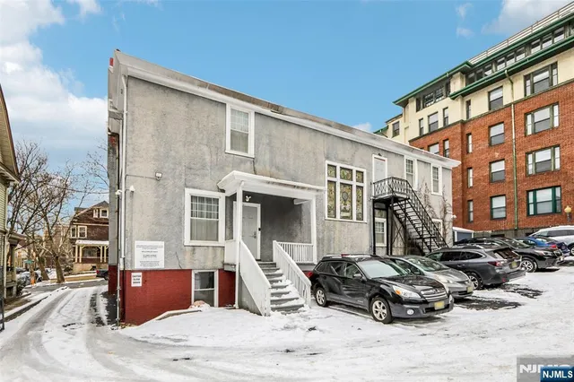 a car parked in front of brick building