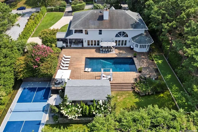 an aerial view of a house with garden space and street view