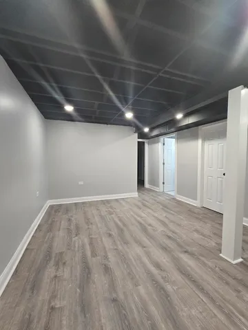 an empty room with wooden floor