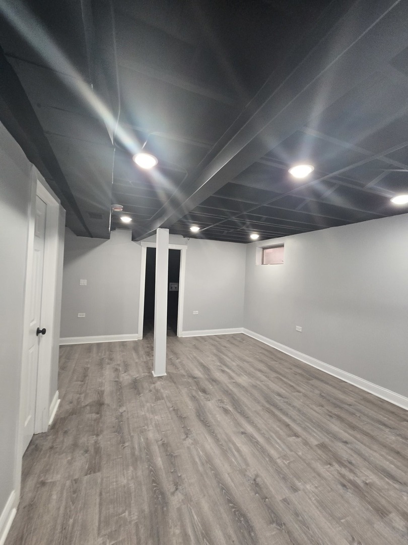 9727 South Michigan Avenue Chicago, IL 60628 - Photo 15 of 24 an empty room with wooden floor