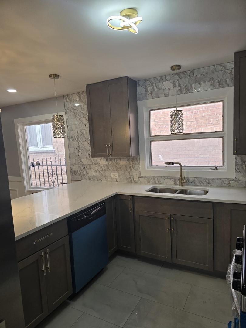 9727 South Michigan Avenue Chicago, IL 60628 - Photo 19 of 24 a kitchen with a sink and cabinets