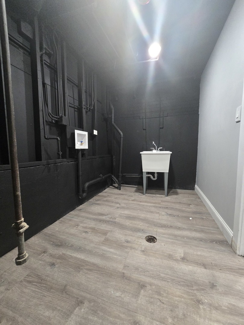 9727 South Michigan Avenue Chicago, IL 60628 - Photo 22 of 24 a bathroom with a sink and mirror