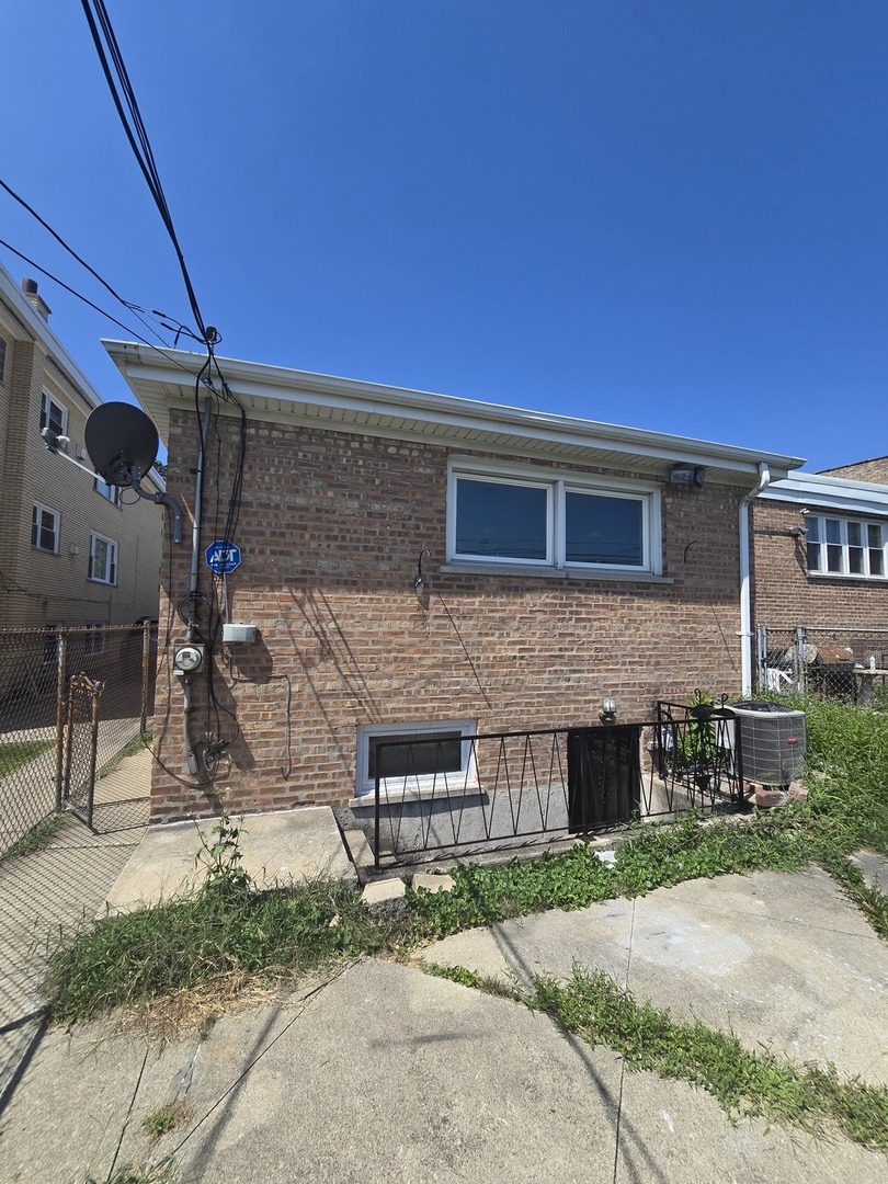 9727 South Michigan Avenue Chicago, IL 60628 - Photo 23 of 24 a brick building with a bench in front of it