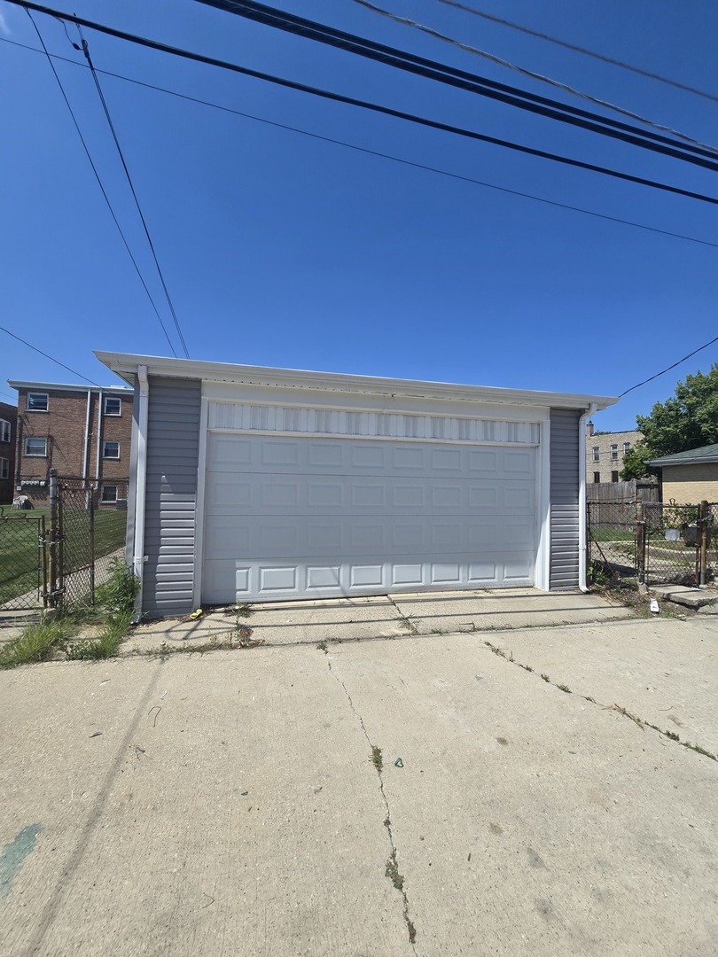 9727 South Michigan Avenue Chicago, IL 60628 - Photo 24 of 24 a view of parking space with a barbeque and wooden fence