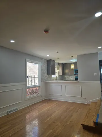 a kitchen with granite countertop white cabinets and a dishwasher