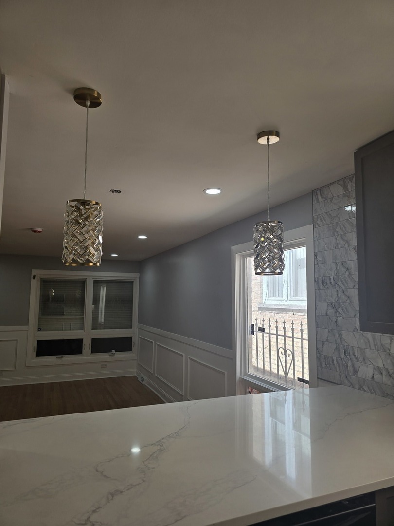 9727 South Michigan Avenue Chicago, IL 60628 - Photo 6 of 24 a view of an empty room with a window and fireplace