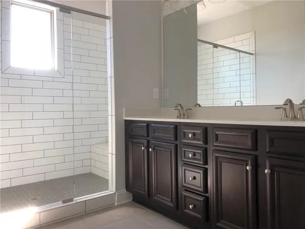 a bathroom with a sink a vanity and a shower