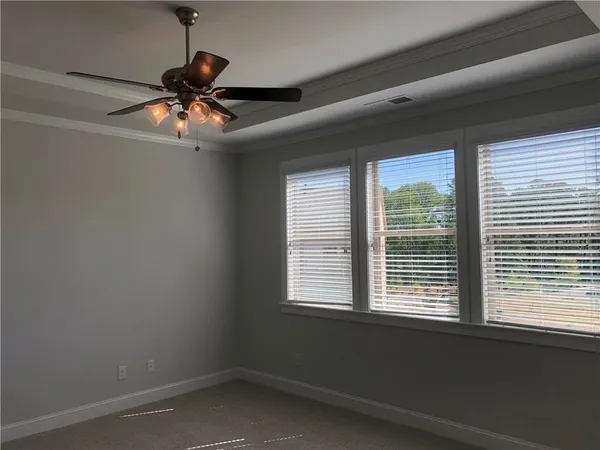 a view of a livingroom with a ceiling fan and window