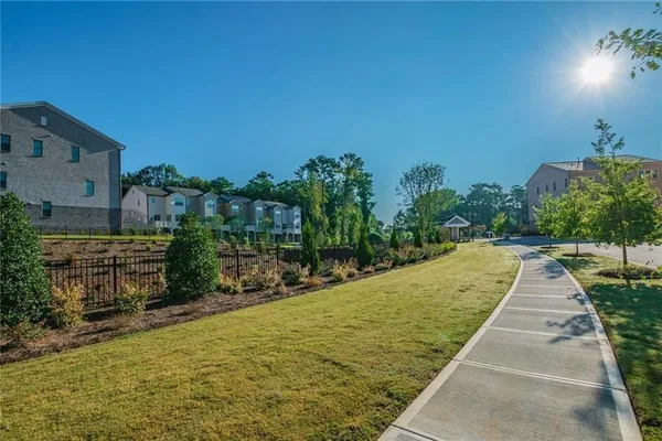 a front view of a house with a large window and glass door
