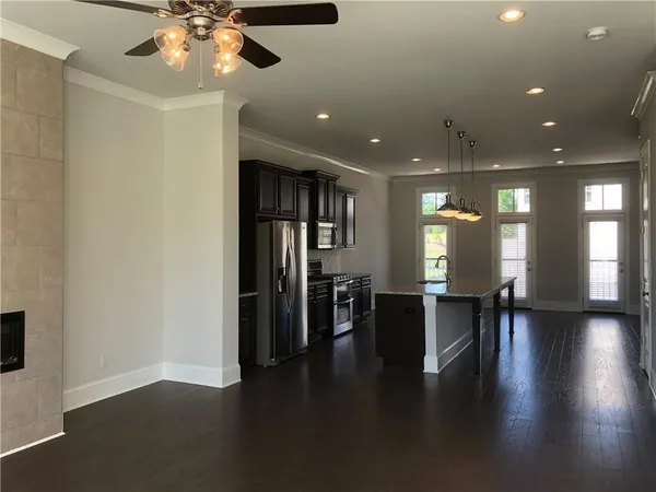a view of a room with furniture and wooden floor