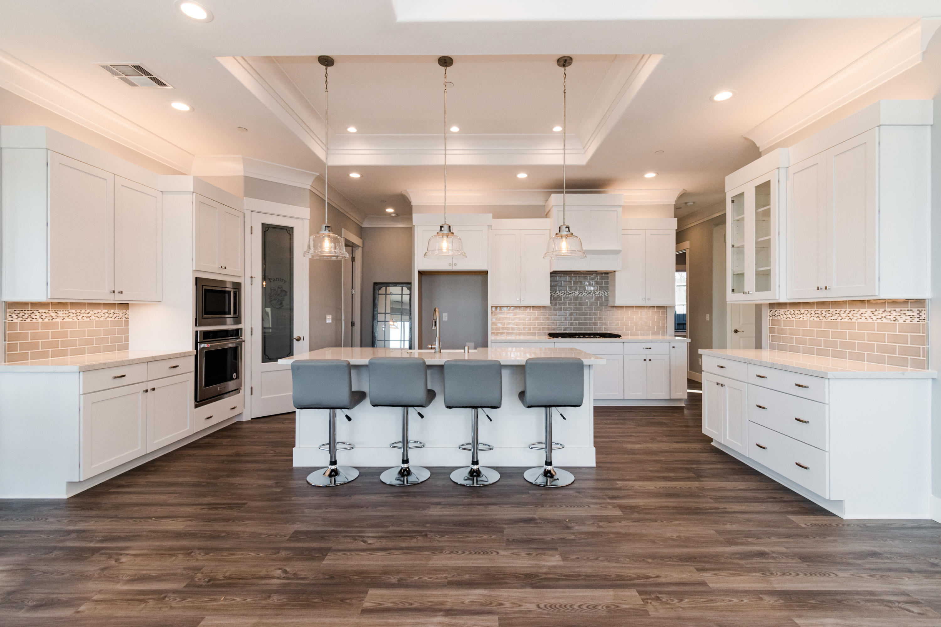 808 River Bend Road Redding, CA 96003 - Photo 13 of 43 a large kitchen with cabinets and wooden floor