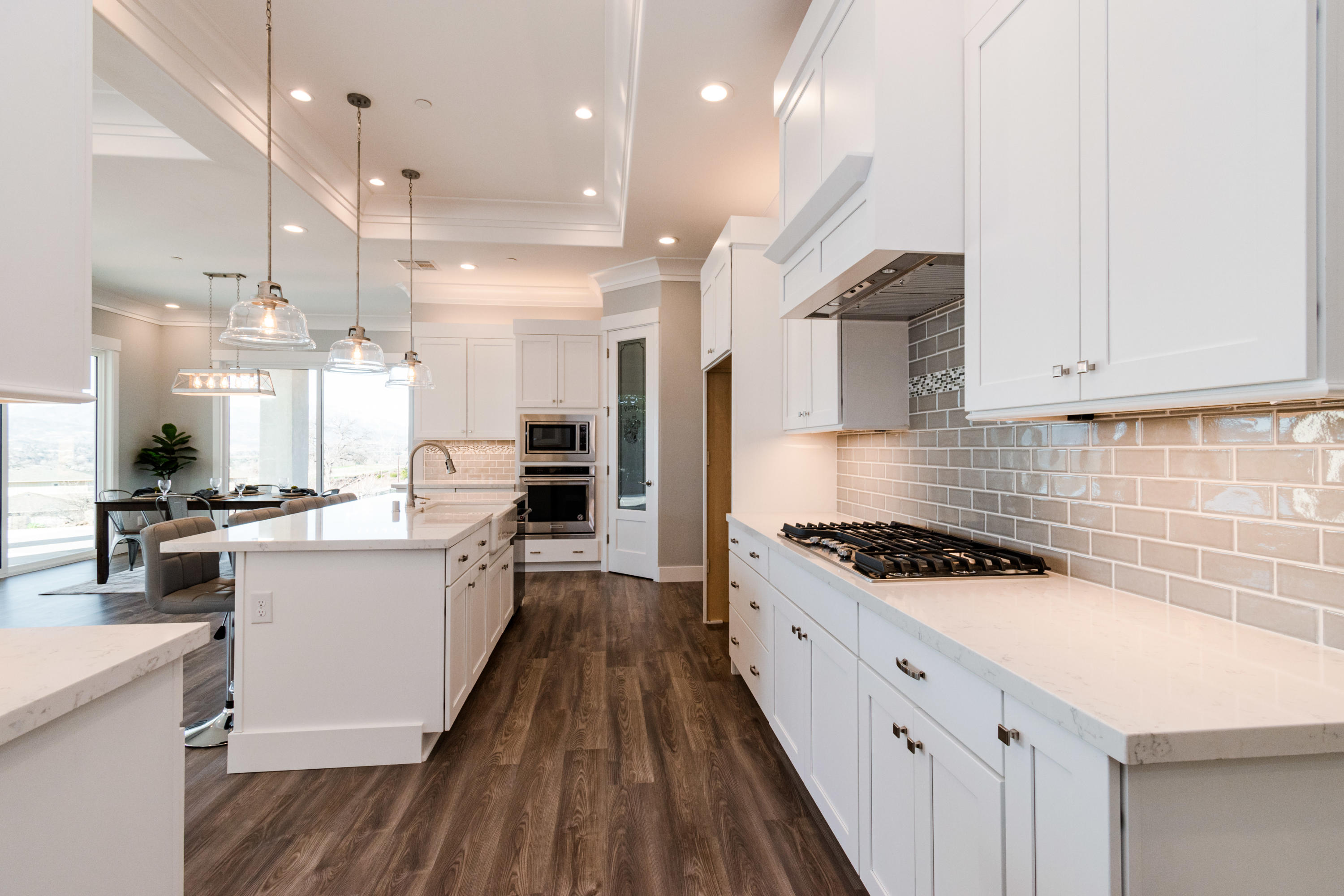 808 River Bend Road Redding, CA 96003 - Photo 15 of 43 a kitchen with stainless steel appliances a stove a sink a refrigerator white cabinets and wooden floor