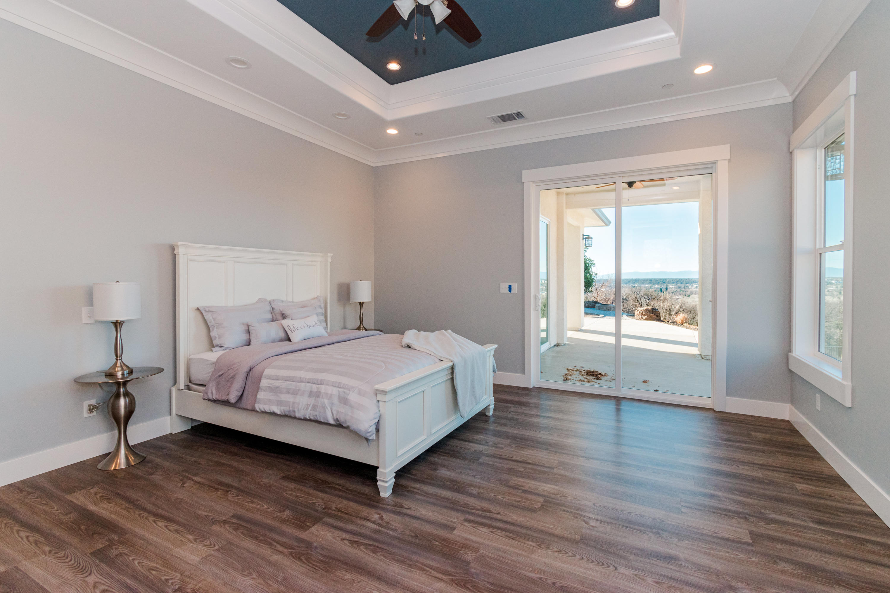 808 River Bend Road Redding, CA 96003 - Photo 17 of 43 a bedroom with a bed and wooden floor